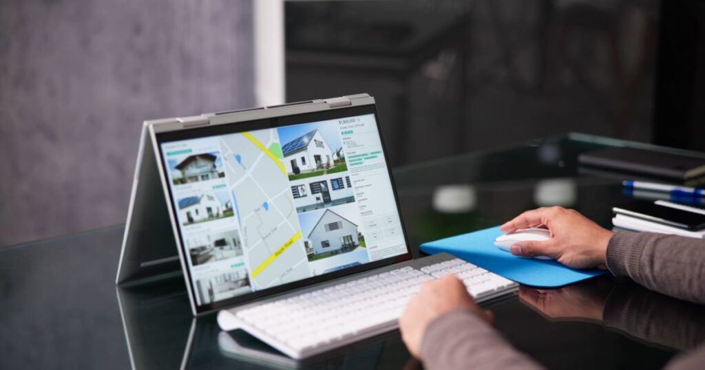 Closeup of a person's hands using a mouse for a tablet or iPad connected to a keyboard.