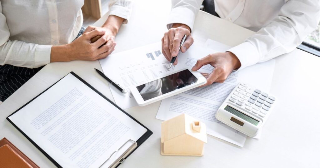 Unidentified man and woman going over real estate reports and paperwork.