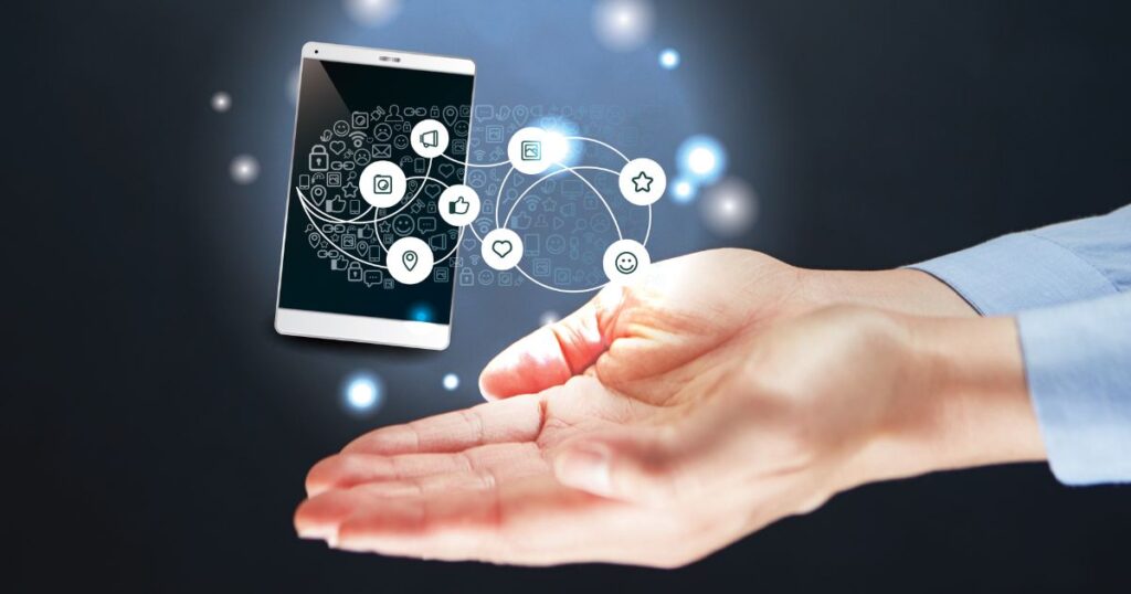 Closeup of a person's cupped hands. Floating above them is a small tablet or iPad and different icons used in Facebook to represent the social media app.