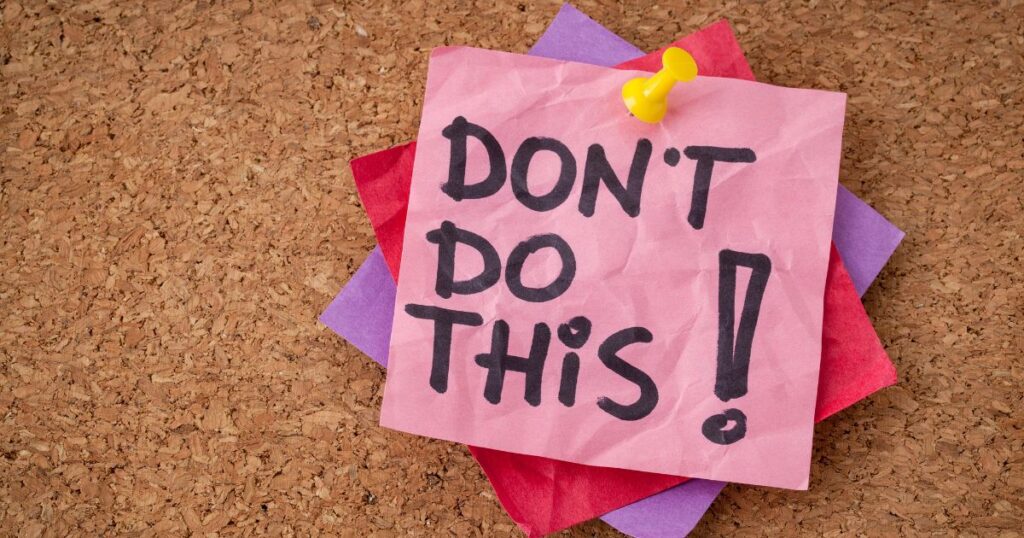 Lightly crumpled Post It Notes thumb-tacked to a cork board, with the top Post It Note reading Don't Do This!