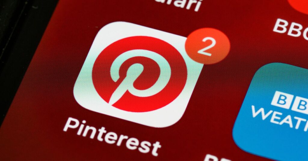 Closeup view of the Pinterest app icon on a smart device screen with a notification showing the number 2.