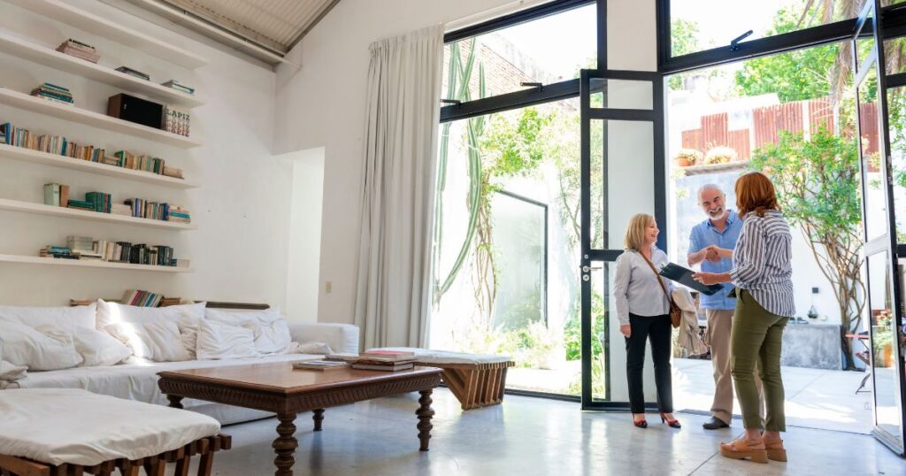 Female real estate agent closing a deal with clients.