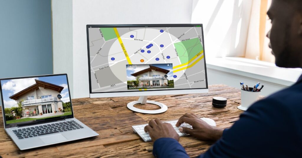 Male realtor at his desk posting a property listing online.