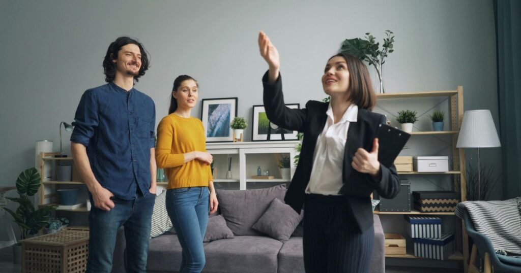 Realtor highlighting a property's feature to her clients.