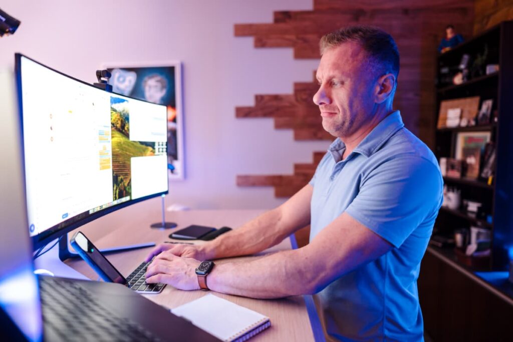 Matt standing at a counter-height desk using a computer.